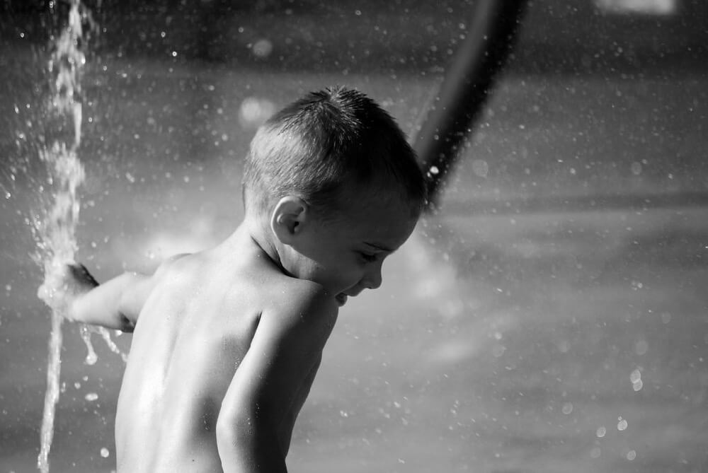 Carissa Rogers - Little Boy in Sprinkler black and white