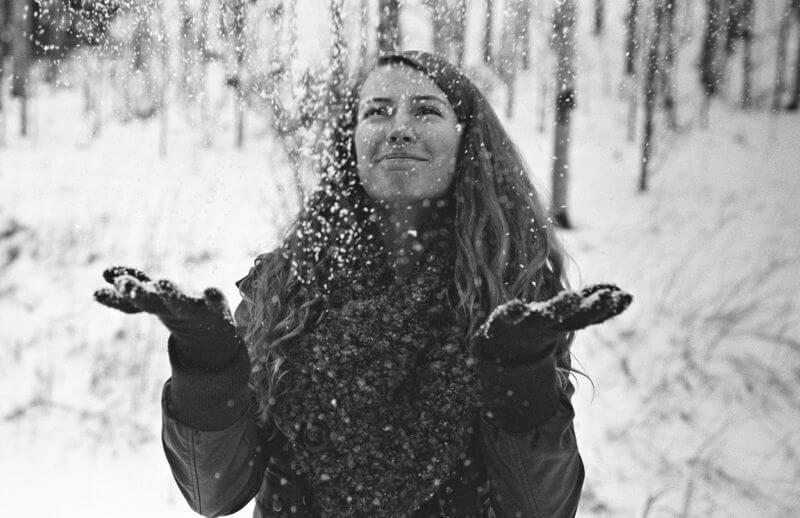 christmas portrait of girl throwing snow