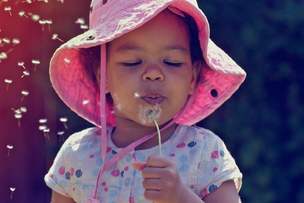 Nana B Agyei - child blowing dandelion