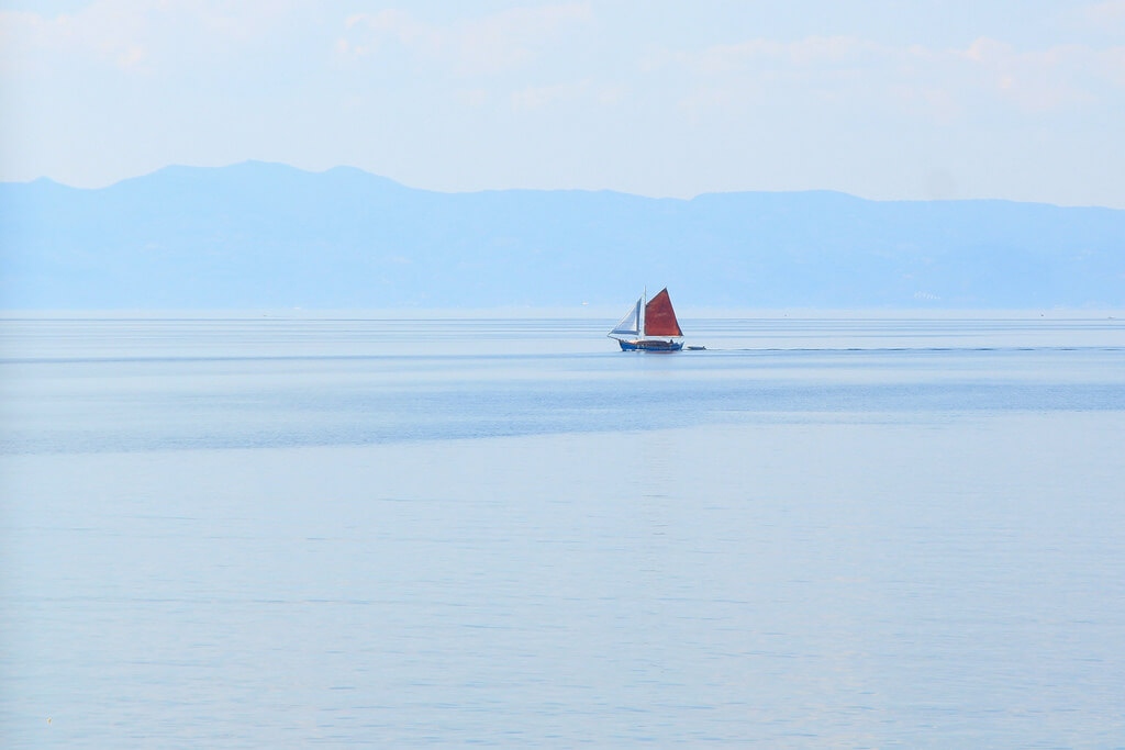 Omer Unlu - Red Sail Ship - minimalist photography