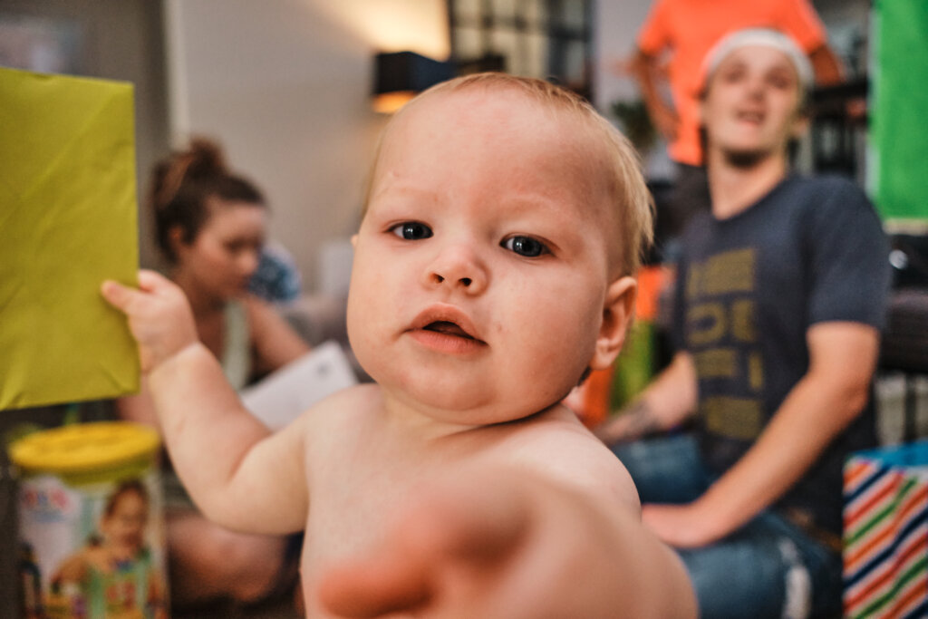 One-year old at his first birthday party photographed in documentary style