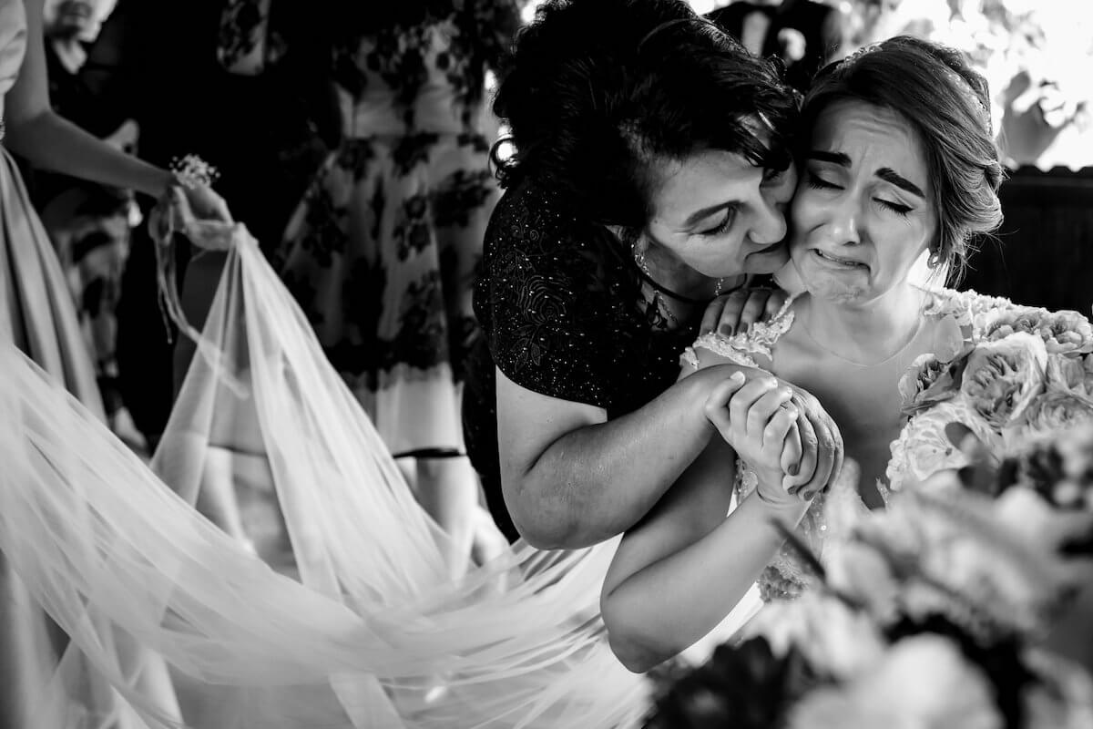 Family kisses bride before wedding