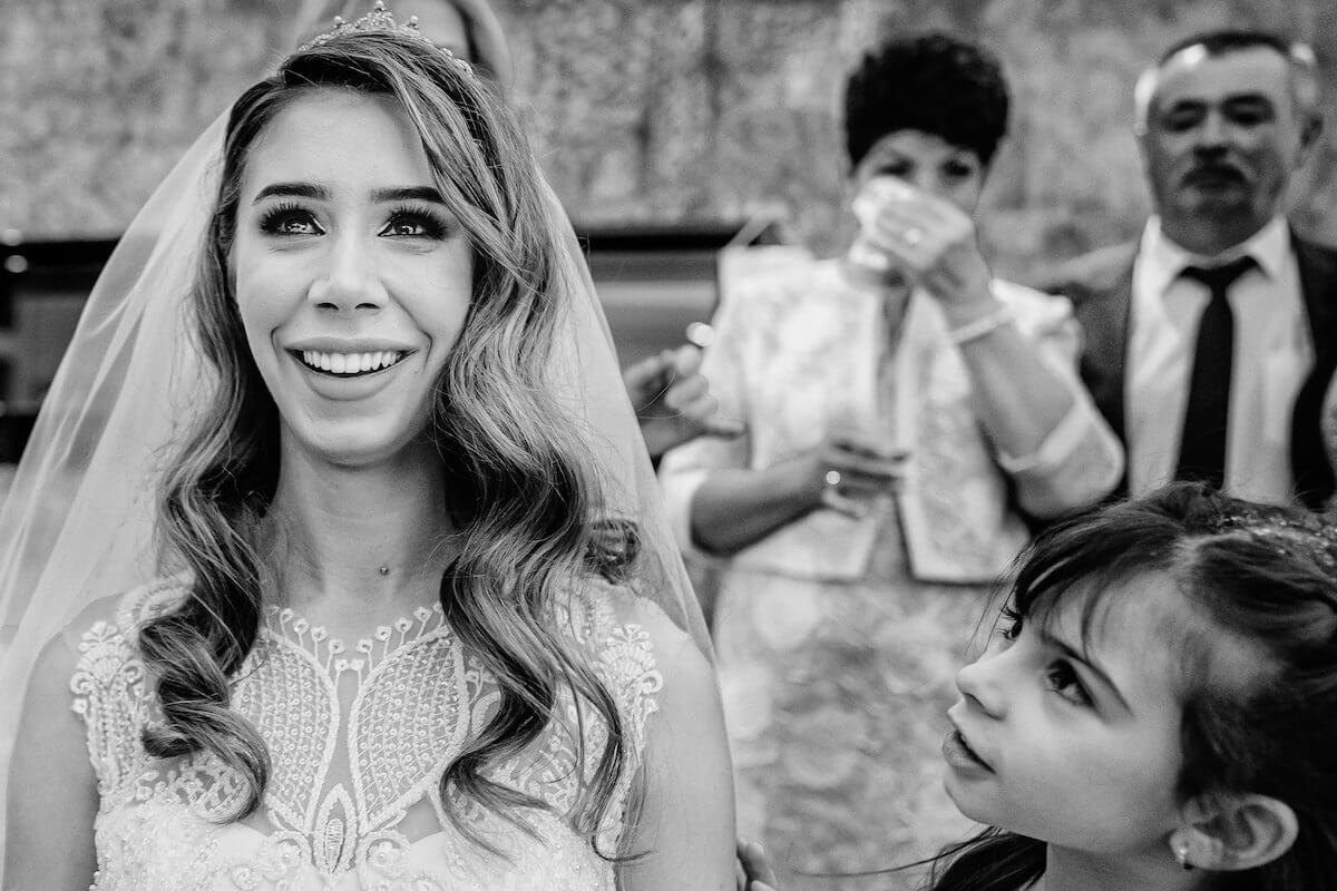 young girl looks at bride with tears